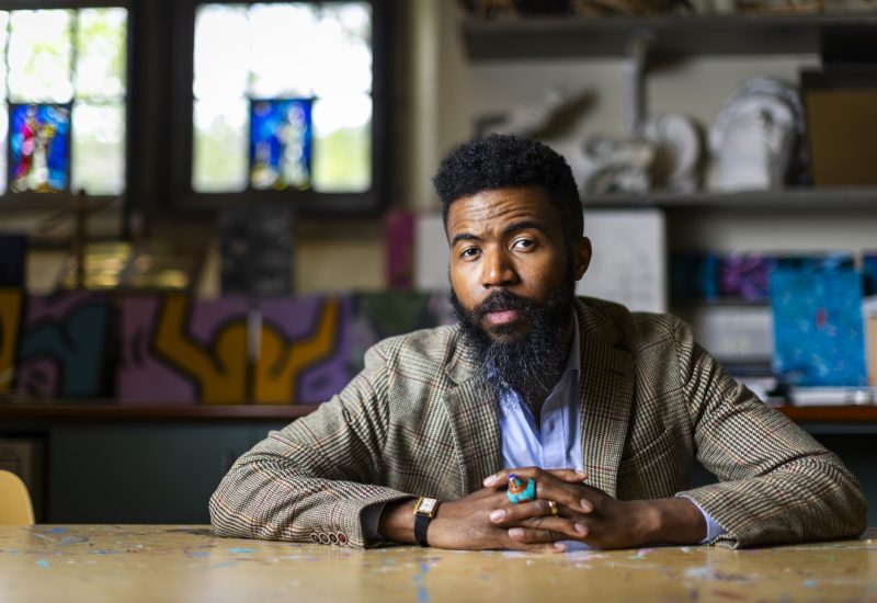 Author Joshua Bennett, Professor of Literature and Distinguished Chair of the Humanities at MIT, poses for a portrait at Thayer Academy in Braintree, MA on May 17, 2024. Photo by Adam Glanzman
